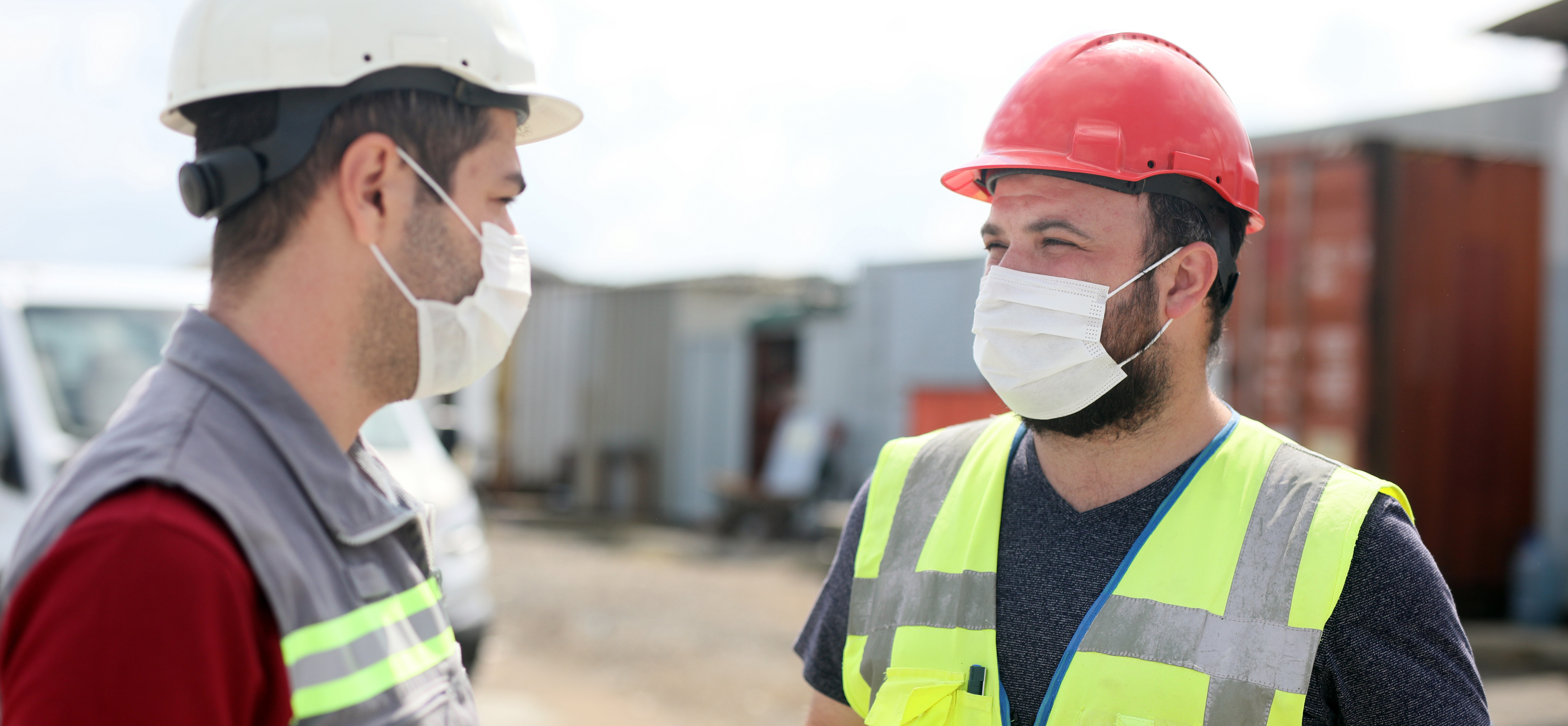 Two workers with protective masks on